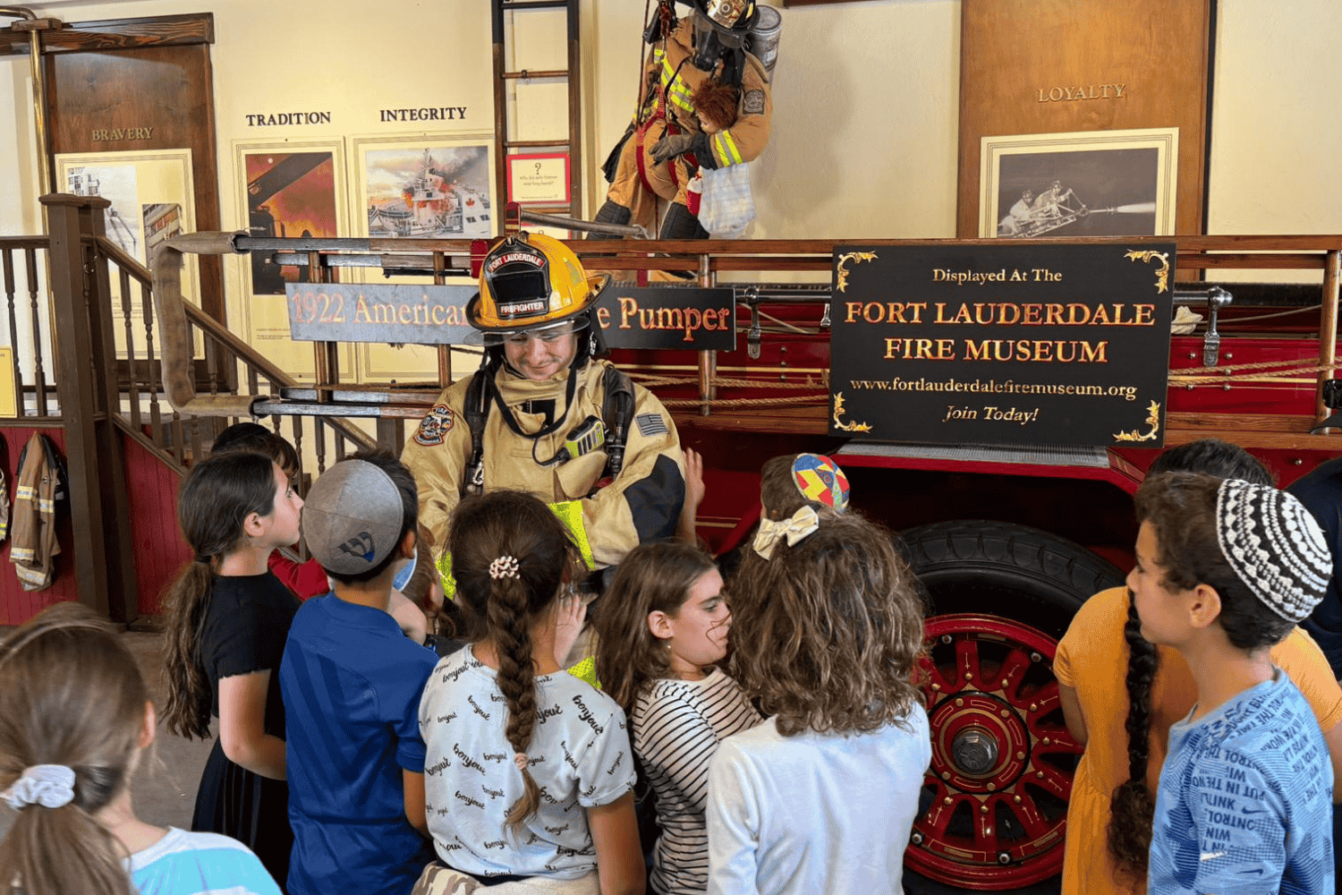 Students learning about firefighting during a guided tour at the Fort Lauderdale Fire and Safety Museum.