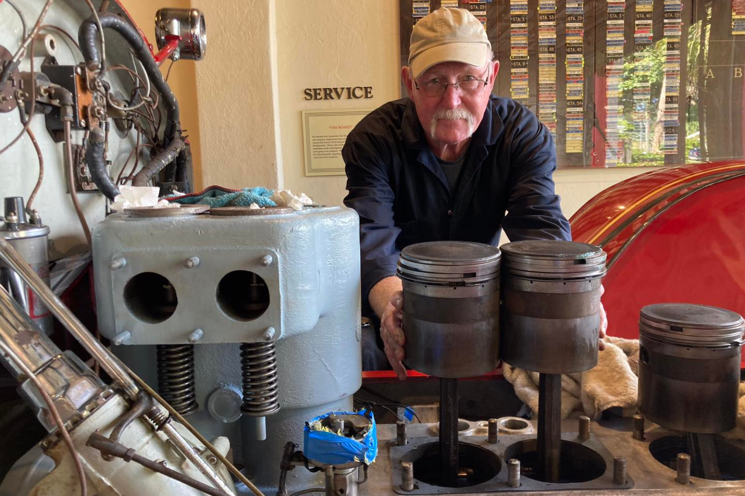 fort-lauderdale-fire-museum-fire-truck-piston-rebuild Volunteer restoring pistons for a 1920s LaFrance fire engine at the Fort Lauderdale Fire and Safety Museum.