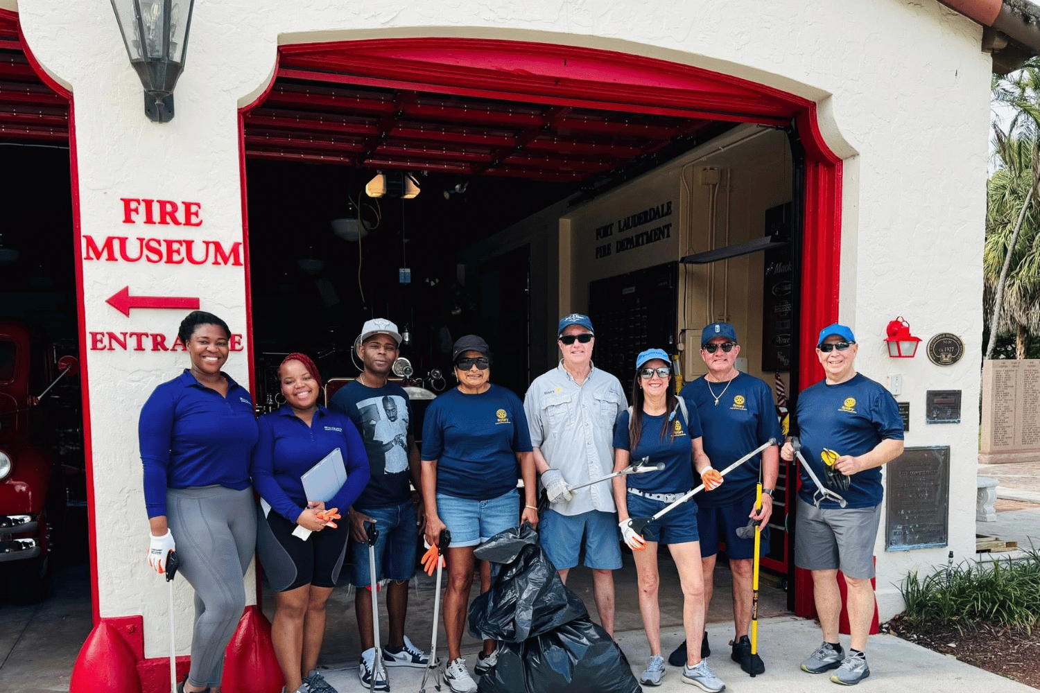 Volunteers standing outside the Fort Lauderdale Fire and Safety Museum after a community cleanup event supporting the historic firehouse.